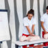 CPR class with instructors talking and demonstrating firt aid, compressions ans reanimation procedure. Cpr dummy on the table.