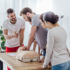 group of people with cpr dummy during first aid training class